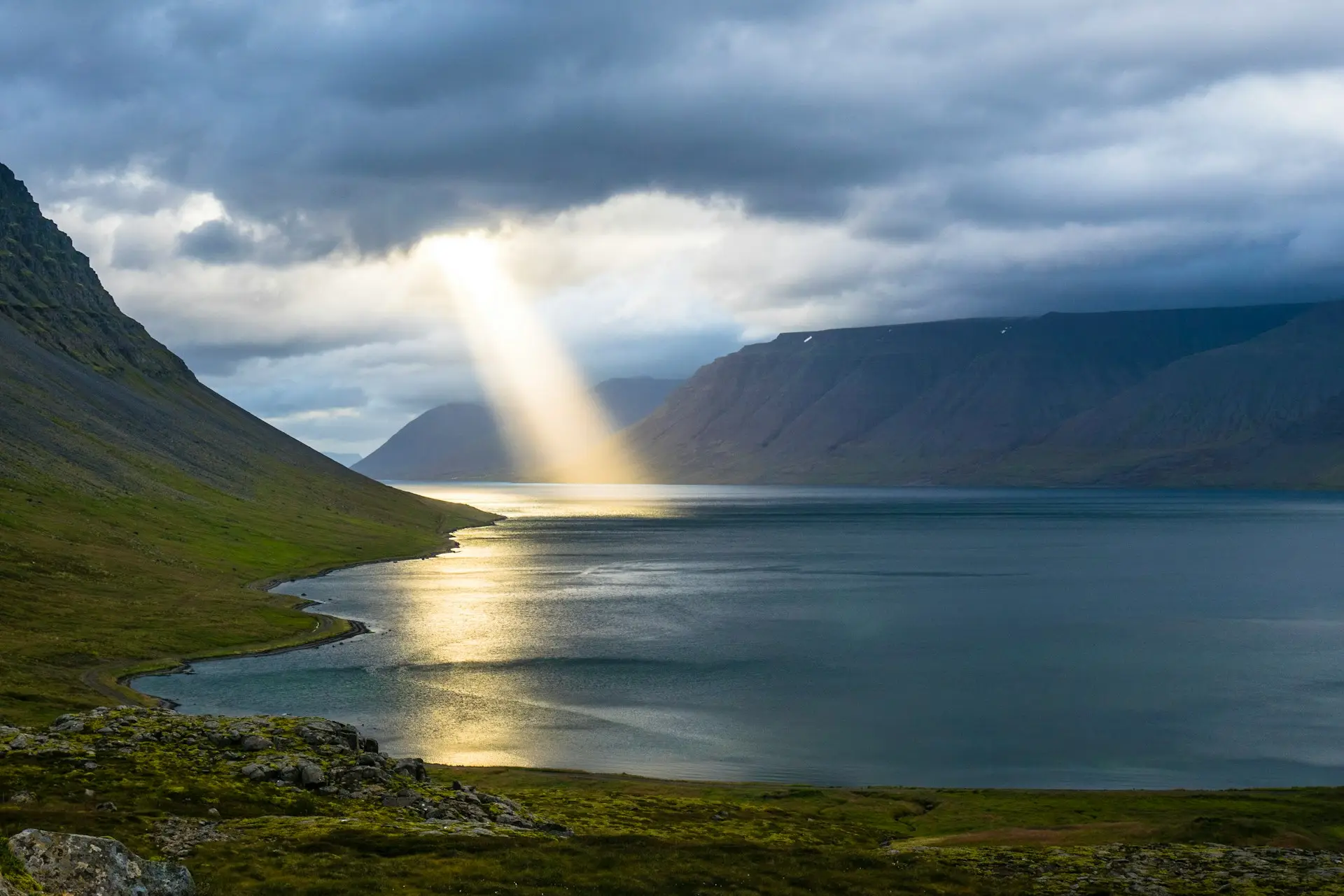 Light beam shining on mountain lake
